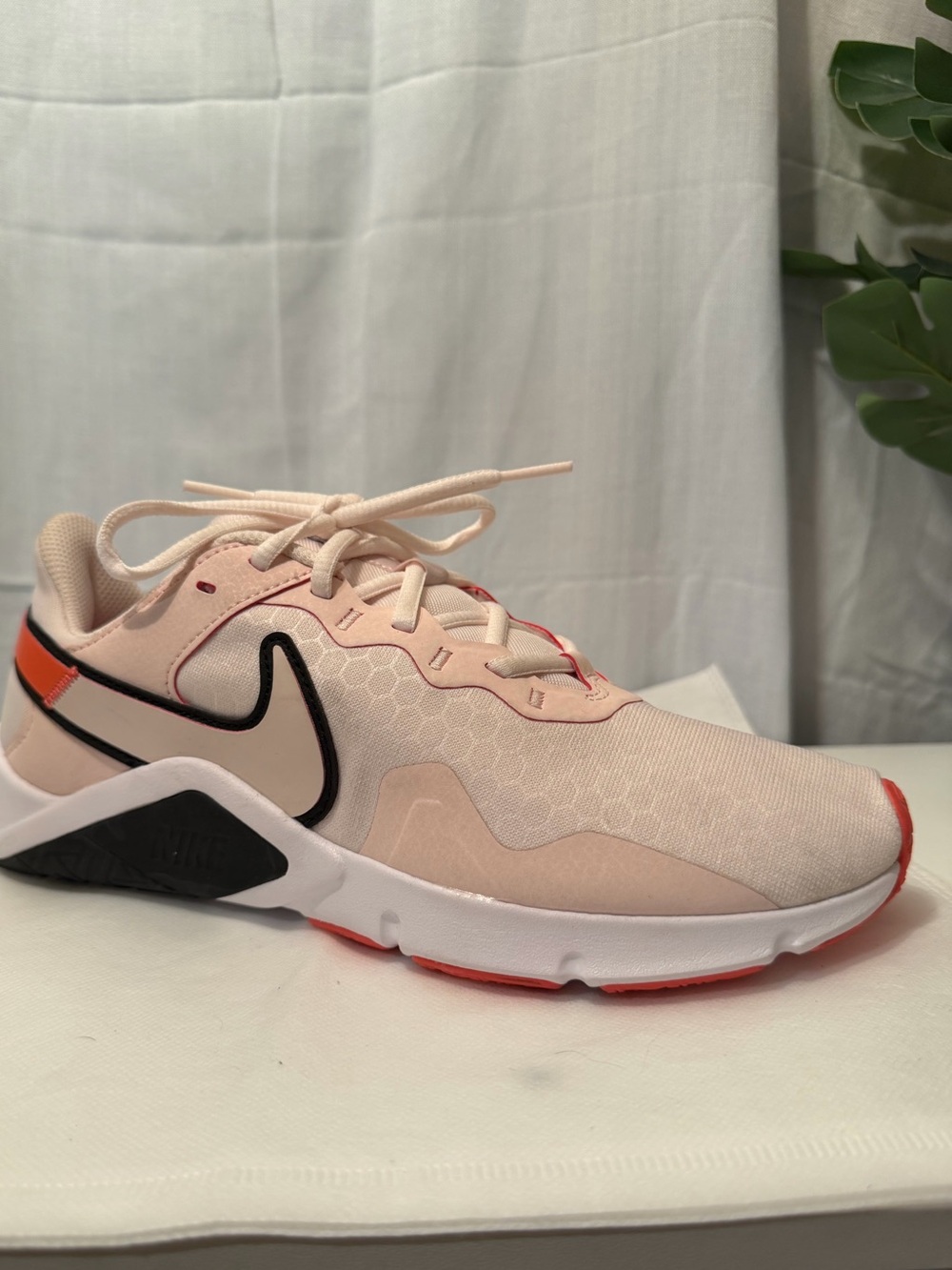 Nike Women's Light Pink Athletic Sneakers with Black Swoosh and Orange Accents